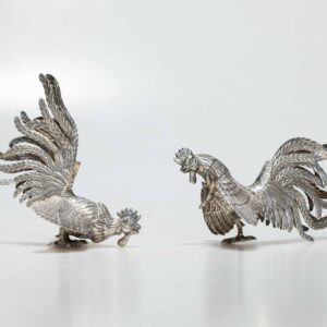 Two silver roosters