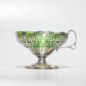 Silver bowl with green glass